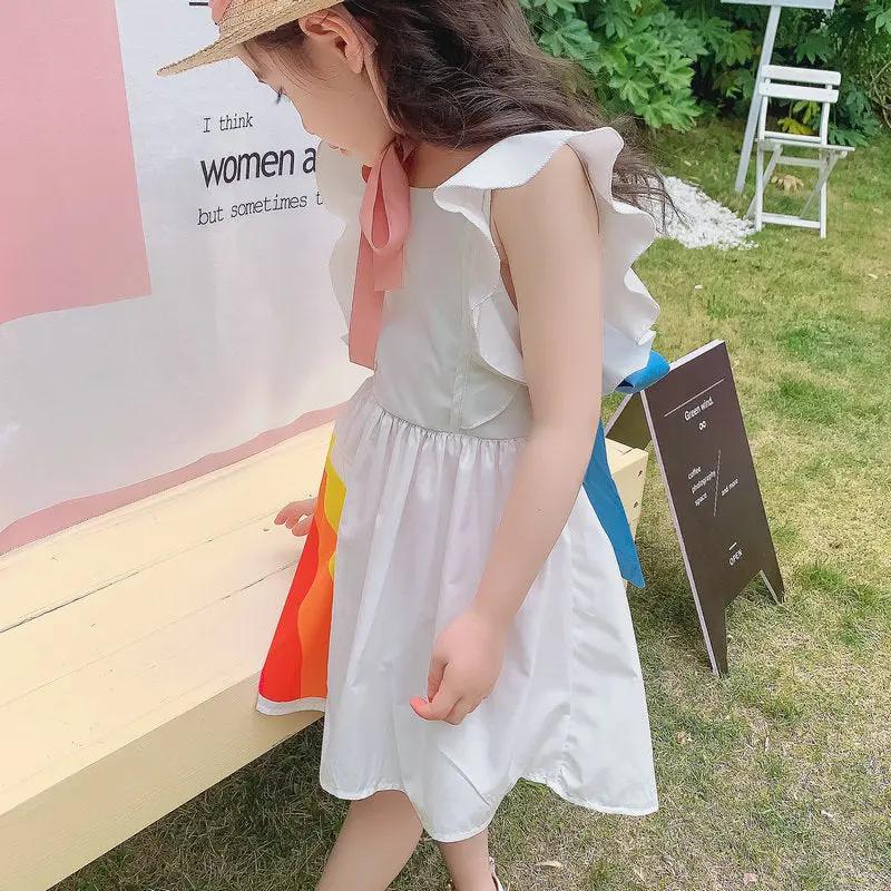 Vibrant rainbow dress with a pink bow, perfect for brightening any child's wardrobe. A&S Collection