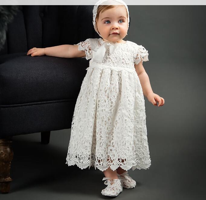 Elegant white lace dress with intricate patterns, short sleeves, and a scalloped hem for a timeless, classic look A&S Collection