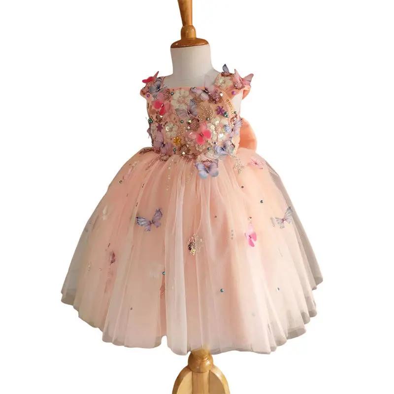 Elegant peach flower girl dress with butterfly and floral embellishments. A&S Collection