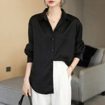 Elegant silk blouses in white, beige, olive, and black, neatly hung on wooden hangers A&S Collection