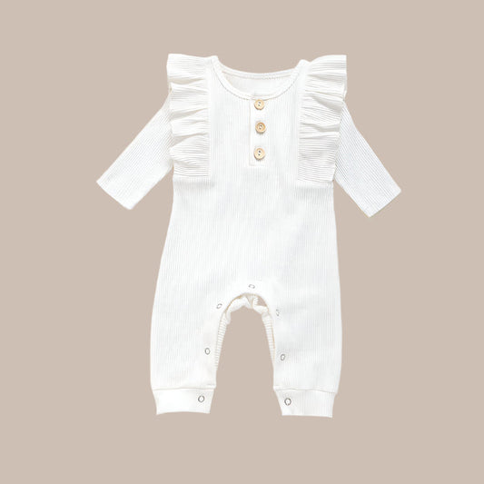 This adorable long sleeve ruffle romper features ribbed fabric with ruffled shoulders and wooden button accents, perfect for baby's cute and comfy style. A&S Collection