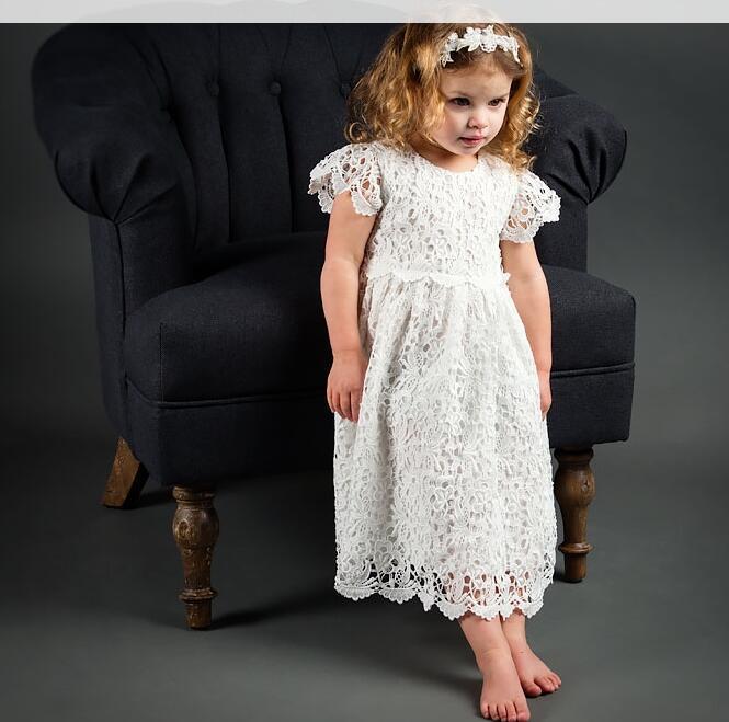Elegant white lace dress with intricate patterns, short sleeves, and a scalloped hem for a timeless, classic look A&S Collection