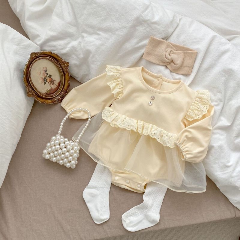 Cream baby romper with lace ruffles, two chest buttons, and a tulle overlay skirt, perfect for special occasions A&S Collection