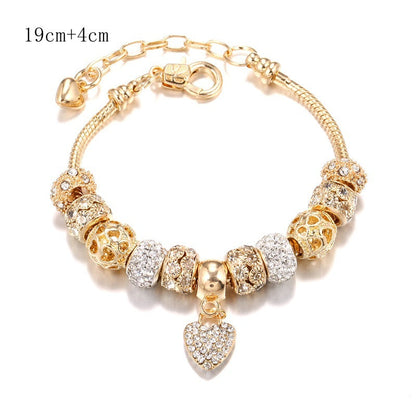 Charming gold bracelet: intricate charms and crystals for a touch of elegance. A&S Collection