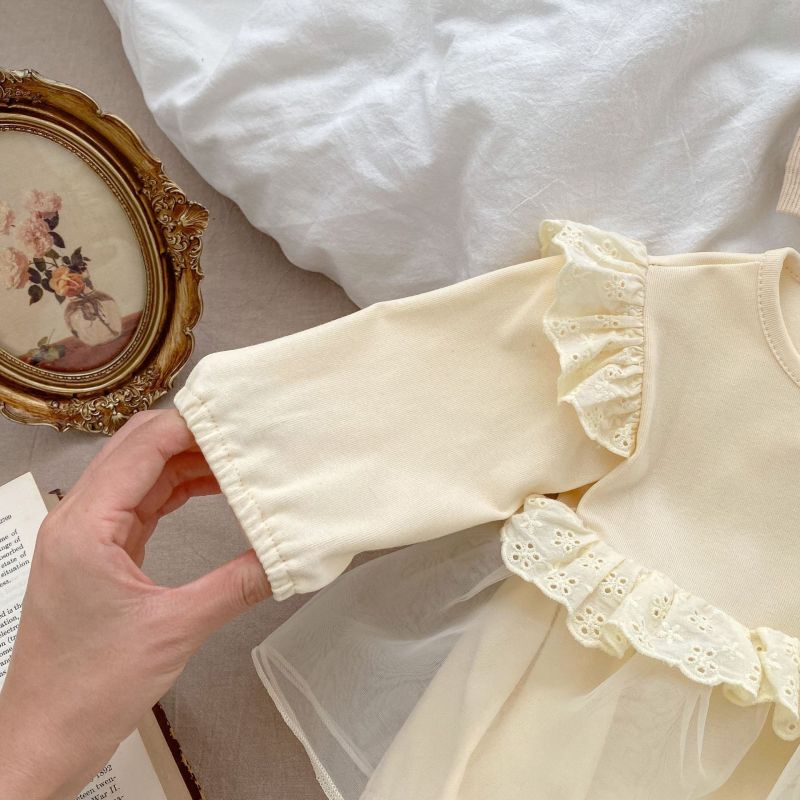 Cream baby romper with lace ruffles, two chest buttons, and a tulle overlay skirt, perfect for special occasions A&S Collection