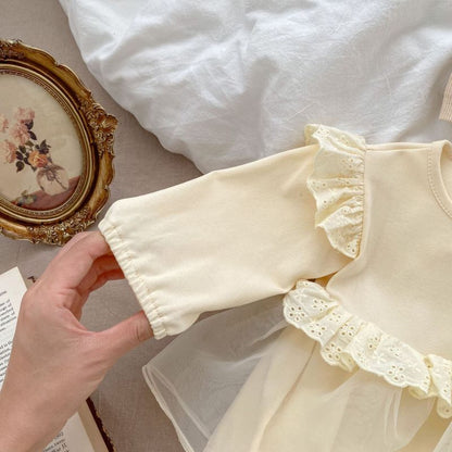 Cream baby romper with lace ruffles, two chest buttons, and a tulle overlay skirt, perfect for special occasions A&S Collection