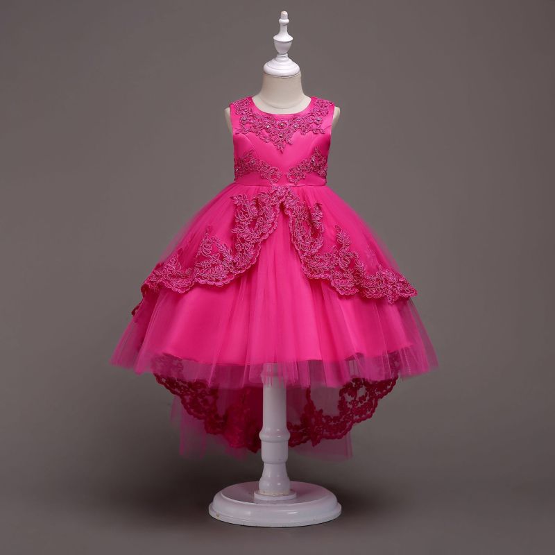Elegant white flower girl dress with intricate lace and high-low hem. A&S Collection