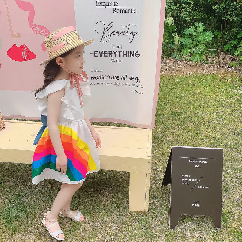 Vibrant rainbow dress with a pink bow, perfect for brightening any child's wardrobe. A&S Collection