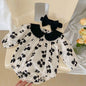 Adorable baby romper with a black floral pattern and matching headband, perfect for a chic and stylish look A&S Collection