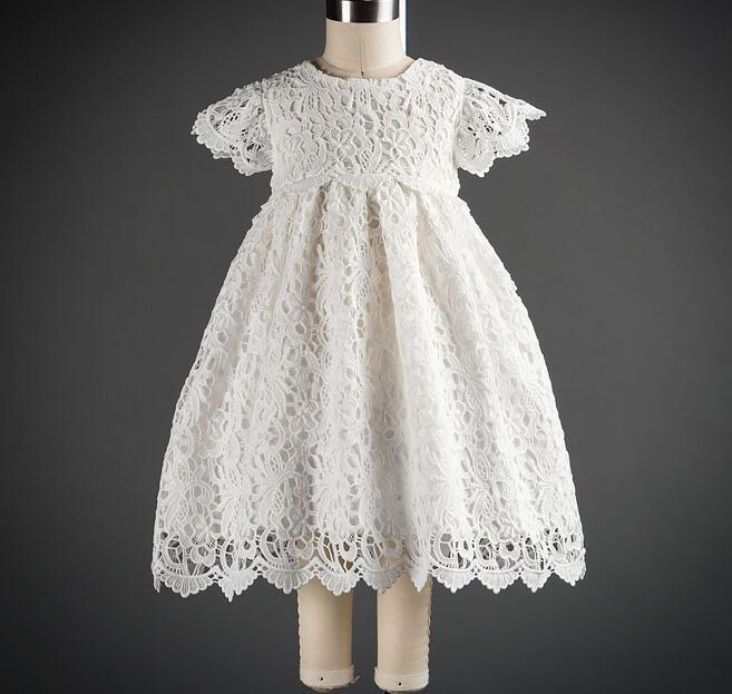 Elegant white lace dress with intricate patterns, short sleeves, and a scalloped hem for a timeless, classic look A&S Collection