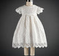 Elegant white lace dress with intricate patterns, short sleeves, and a scalloped hem for a timeless, classic look A&S Collection