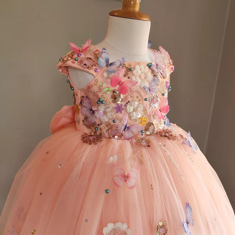 Elegant peach flower girl dress with butterfly and floral embellishments. A&S Collection