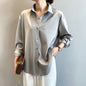 Elegant silk blouses in white, beige, olive, and black, neatly hung on wooden hangers A&S Collection