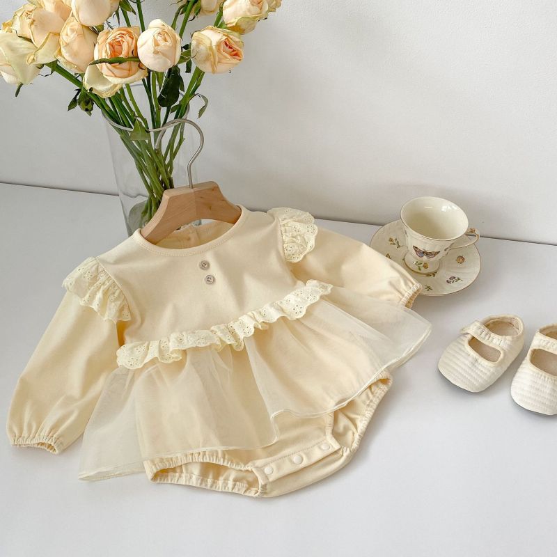 Cream baby romper with lace ruffles, two chest buttons, and a tulle overlay skirt, perfect for special occasions A&S Collection