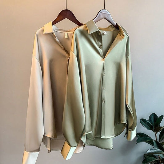 Elegant silk blouses in white, beige, olive, and black, neatly hung on wooden hangers A&S Collection