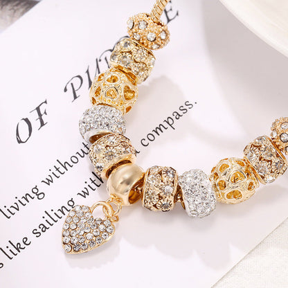 Charming gold bracelet: intricate charms and crystals for a touch of elegance. A&S Collection