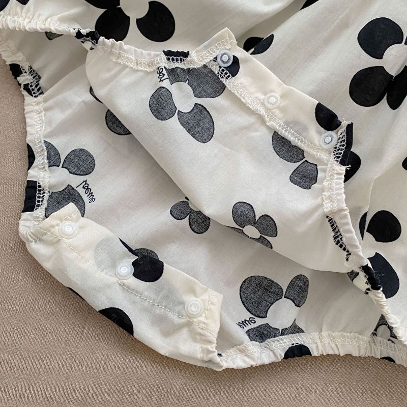 Adorable baby romper with a black floral pattern and matching headband, perfect for a chic and stylish look A&S Collection