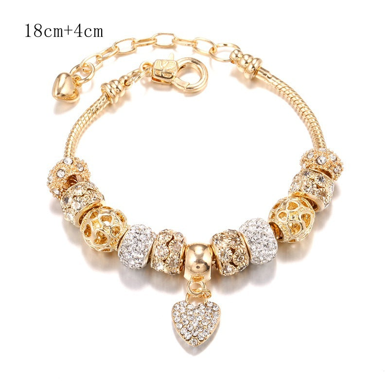 Charming gold bracelet: intricate charms and crystals for a touch of elegance. A&S Collection